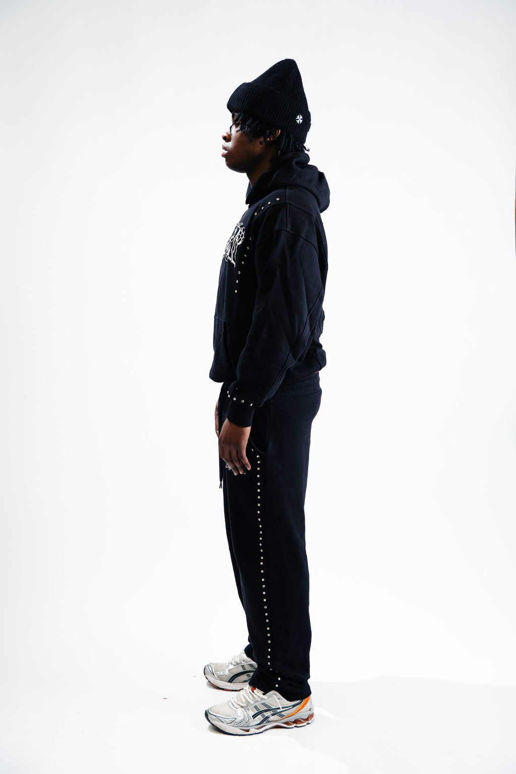 Model wearing CHACHI Signature Hoodie in black, side view