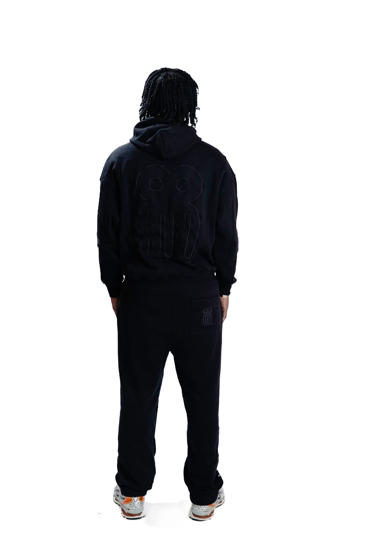 Model wearing CHACHI Signature Hoodie in black, close-up detail